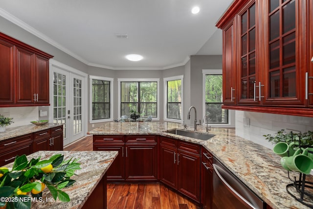 725 Carthage Pl, Saint Johns, FL 32259 - kitchen featuring a sink, reddish brown cabinets, dishwasher, dark wood-type flooring, and decorative backsplash