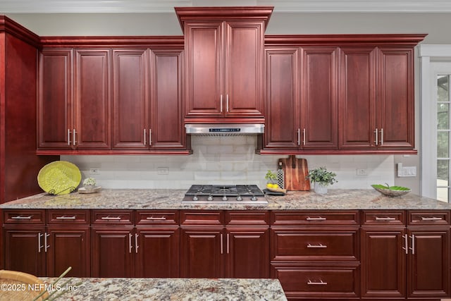 725 Carthage Pl, Saint Johns, FL 32259 - kitchen with reddish brown cabinets, stainless steel gas stovetop, tasteful backsplash, light stone countertops, and ornamental molding