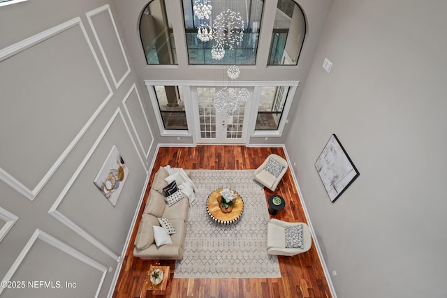 725 Carthage Pl, Saint Johns, FL 32259 - living area with a chandelier, a towering ceiling, wood finished floors, and baseboards