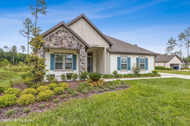 36039 Pitch Ln, Hilliard, FL 32046 - view of front of house with board and batten siding, a front yard, stone siding, and a shingled roof