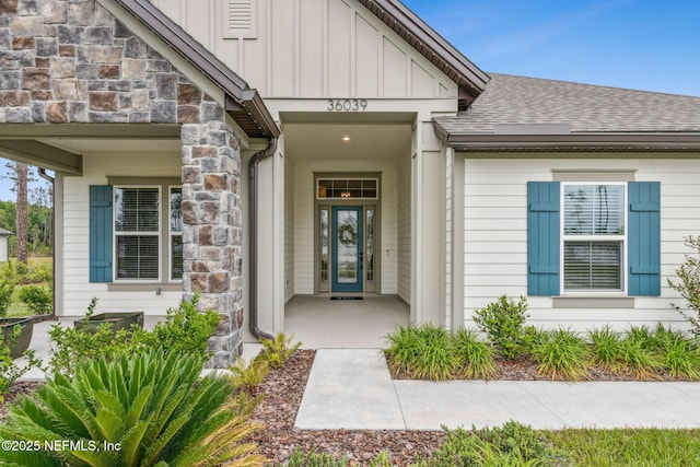 36039 Pitch Ln, Hilliard, FL 32046 - entrance to property with board and batten siding, stone siding, and roof with shingles