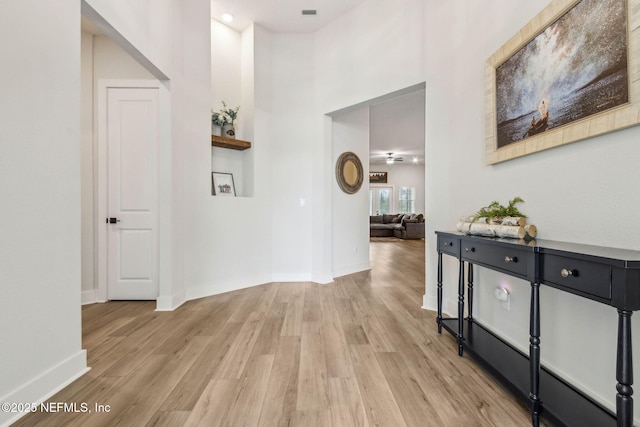 36039 Pitch Ln, Hilliard, FL 32046 - hall featuring light wood-style floors, a high ceiling, and baseboards