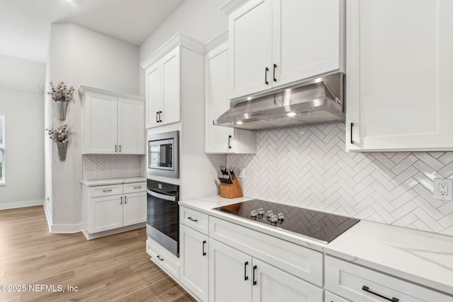 36039 Pitch Ln, Hilliard, FL 32046 - kitchen featuring stainless steel appliances, under cabinet range hood, tasteful backsplash, white cabinetry, and light wood-type flooring