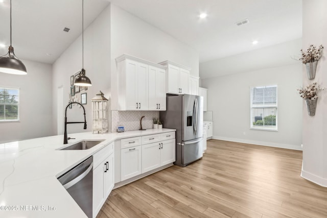 36039 Pitch Ln, Hilliard, FL 32046 - kitchen featuring appliances with stainless steel finishes, a sink, decorative backsplash, healthy amount of natural light, and recessed lighting