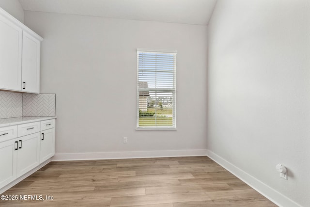 36039 Pitch Ln, Hilliard, FL 32046 - unfurnished dining area featuring light wood finished floors and baseboards