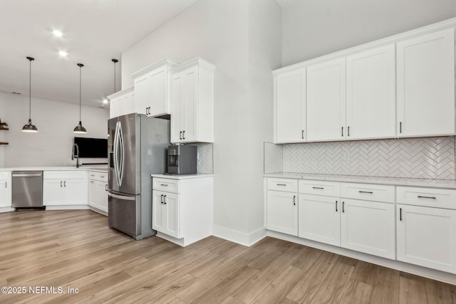 36039 Pitch Ln, Hilliard, FL 32046 - kitchen featuring appliances with stainless steel finishes, light countertops, backsplash, and white cabinets
