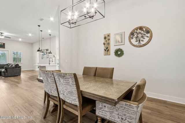 36039 Pitch Ln, Hilliard, FL 32046 - dining area with light wood-type flooring, a chandelier, recessed lighting, and baseboards
