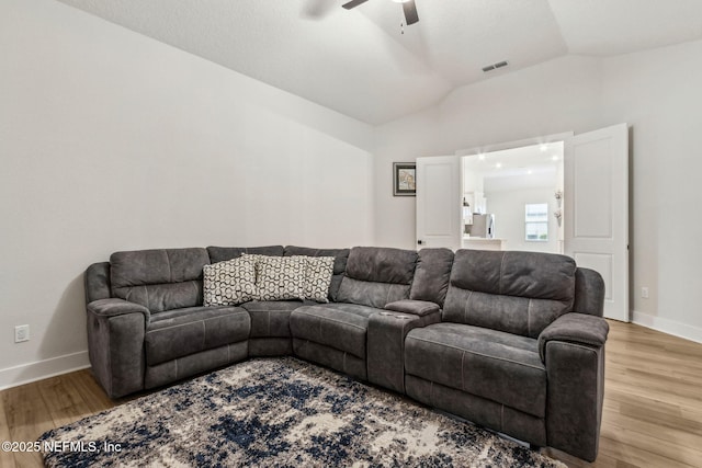 36039 Pitch Ln, Hilliard, FL 32046 - living area featuring lofted ceiling, ceiling fan, wood finished floors, and baseboards