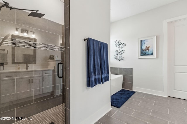 36039 Pitch Ln, Hilliard, FL 32046 - full bath with a shower stall, baseboards, a freestanding tub, tile patterned flooring, and vanity