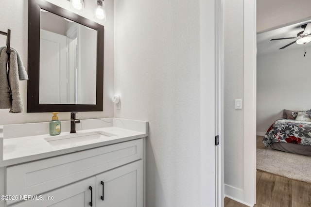 36039 Pitch Ln, Hilliard, FL 32046 - bathroom featuring wood finished floors, vanity, a ceiling fan, and ensuite bathroom