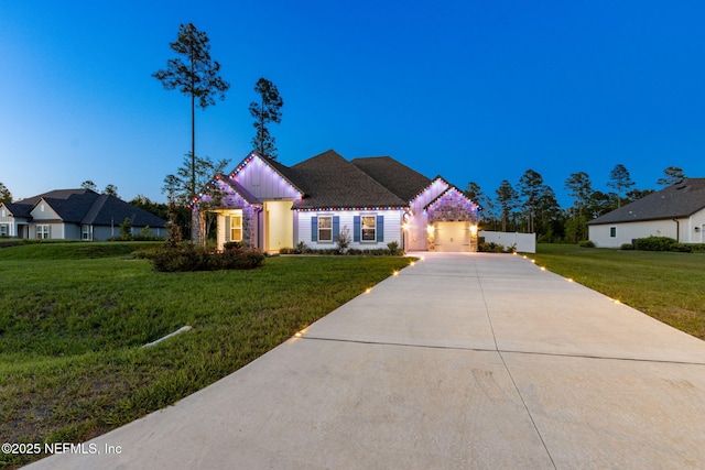 36039 Pitch Ln, Hilliard, FL 32046 - view of front facade with a front yard, driveway, board and batten siding, and a garage