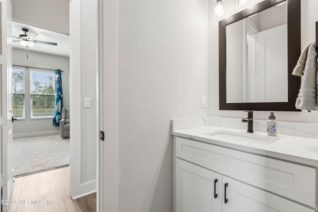36039 Pitch Ln, Hilliard, FL 32046 - bathroom featuring wood finished floors, vanity, a ceiling fan, a textured wall, and baseboards