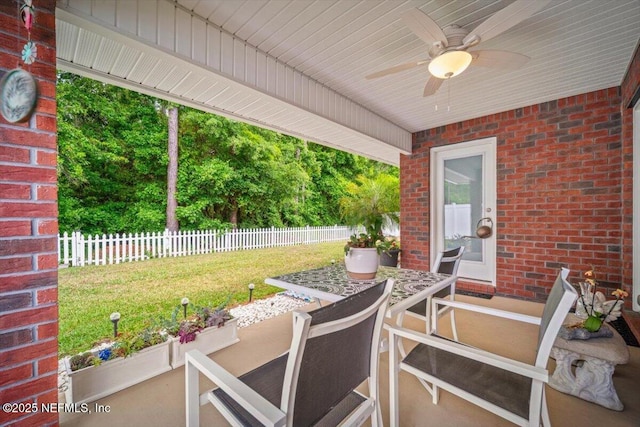 view of patio / terrace featuring fence, outdoor dining space, and ceiling fan