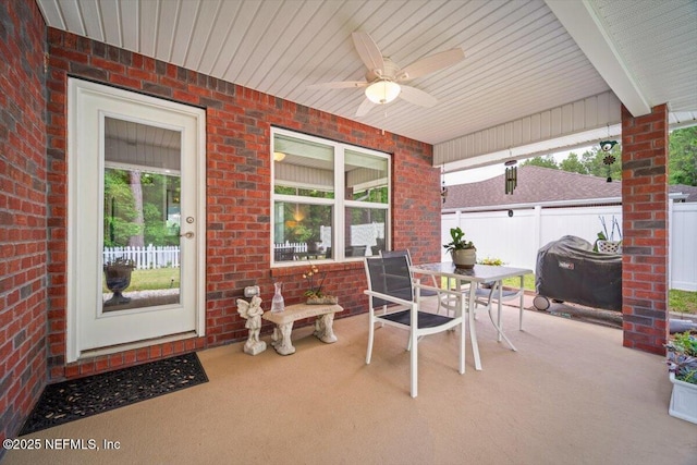 view of patio / terrace with fence, a ceiling fan, outdoor dining space, and area for grilling