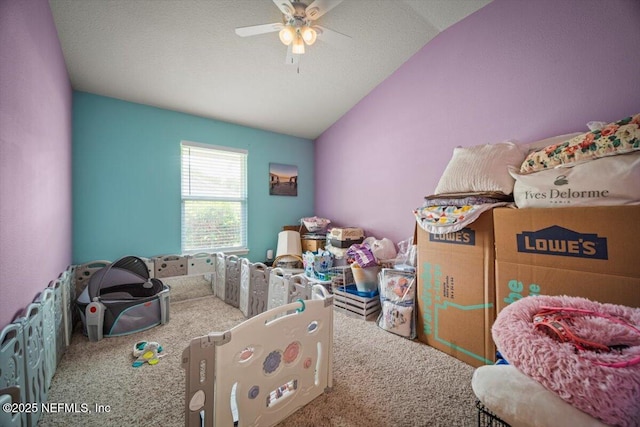 interior space with a ceiling fan, carpet flooring, and lofted ceiling