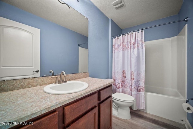full bath featuring visible vents, wood finished floors, vanity, toilet, and shower / bath combo with shower curtain