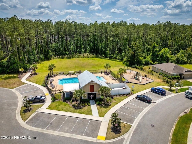 birds eye view of property with a view of trees