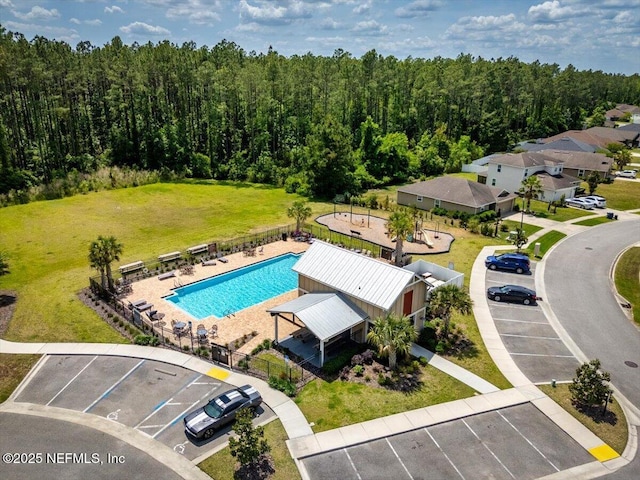 drone / aerial view featuring a wooded view