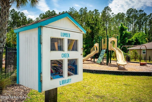 community jungle gym featuring a lawn and fence