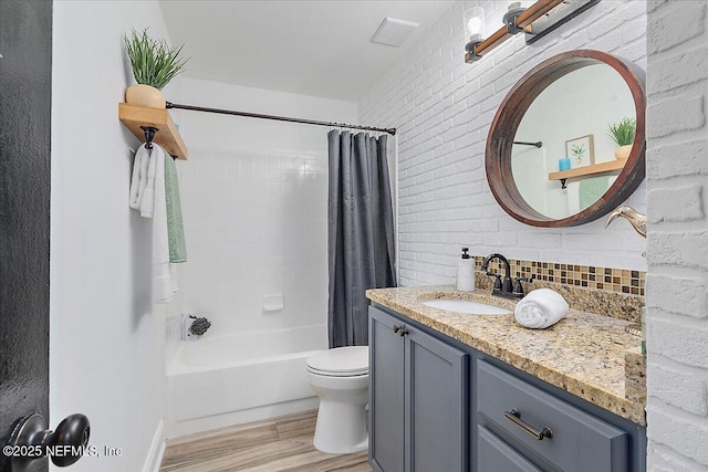 12322 Mastin Cove Rd, Jacksonville, FL 32225 - full bathroom with wood finished floors, vanity, toilet, shower / bath combination with curtain, and decorative backsplash