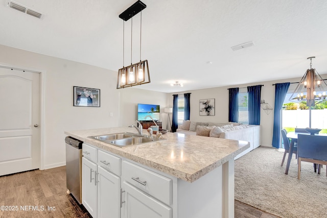 2471 Cold Stream Ln, Green Cove Springs, FL 32043 - kitchen featuring a sink, stainless steel dishwasher, a chandelier, light wood-style floors, and light countertops