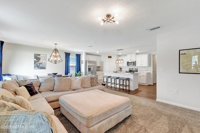 2471 Cold Stream Ln, Green Cove Springs, FL 32043 - living room with a chandelier, light colored carpet, baseboards, and recessed lighting