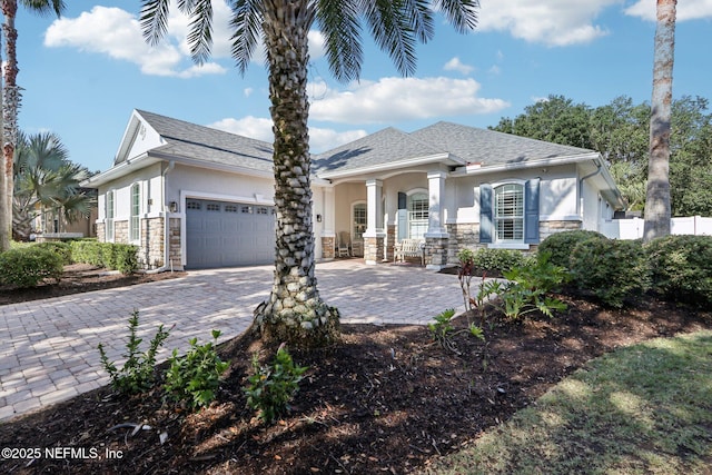 90 Kenmore Ave, Ponte Vedra, FL 32081 - view of front of home featuring stone siding, a garage, stucco siding, decorative driveway, and covered porch