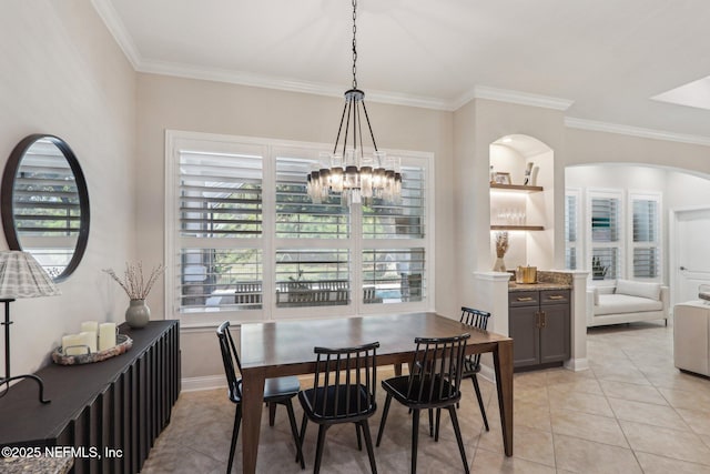 90 Kenmore Ave, Ponte Vedra, FL 32081 - dining space featuring crown molding, light tile patterned flooring, a chandelier, arched walkways, and baseboards
