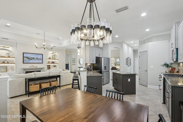 90 Kenmore Ave, Ponte Vedra, FL 32081 - dining room with a chandelier, recessed lighting, crown molding, light tile patterned flooring, and arched walkways