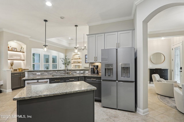 90 Kenmore Ave, Ponte Vedra, FL 32081 - kitchen featuring stainless steel fridge with ice dispenser, a peninsula, ornamental molding, light tile patterned floors, and stone counters