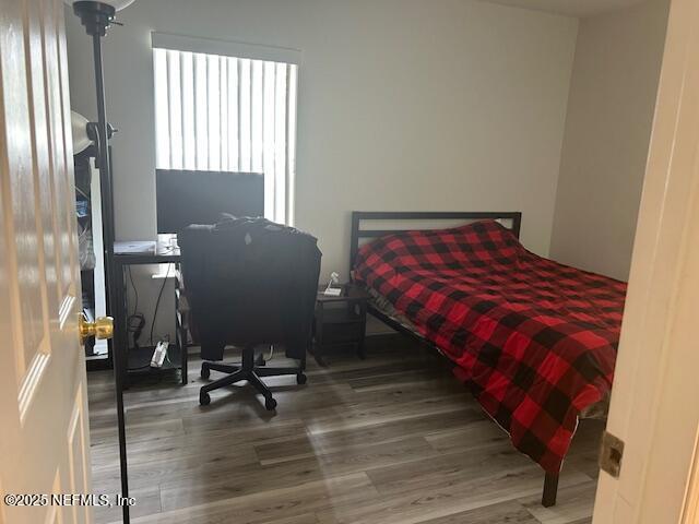 bedroom with wood finished floors