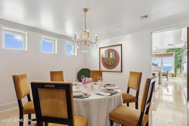 dining room with a chandelier, crown molding, light tile patterned floors, and baseboards