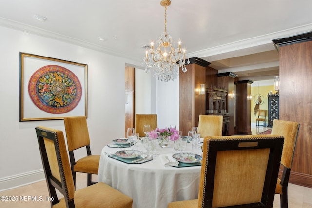 dining room with a chandelier, crown molding, and baseboards