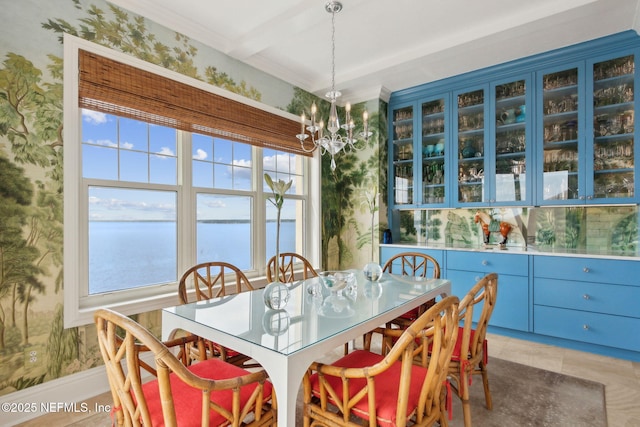 dining area featuring a chandelier, healthy amount of natural light, a water view, wallpapered walls, and light tile patterned floors