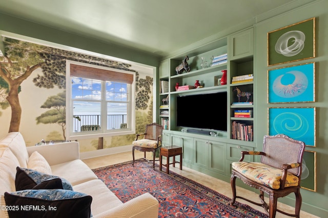 living area featuring baseboards and wallpapered walls