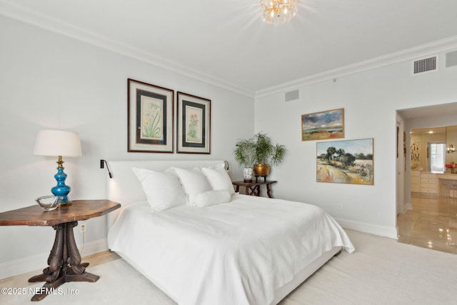 bedroom with baseboards, ornamental molding, a chandelier, and ensuite bathroom