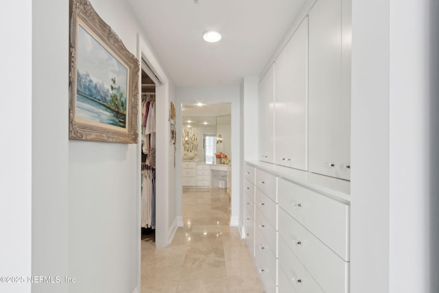 hallway with recessed lighting, light tile patterned floors, and baseboards