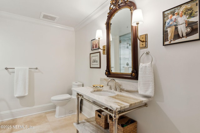 bathroom featuring ornamental molding, toilet, vanity, tile patterned flooring, and baseboards