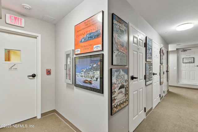 hall with light carpet and baseboards