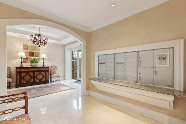 view of property's community featuring arched walkways, ornamental molding, mail area, and a chandelier