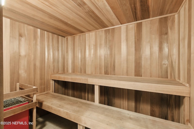 sauna / steam room featuring wood ceiling and wood walls