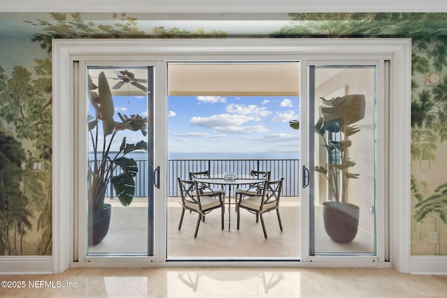 entryway with wallpapered walls and a water view