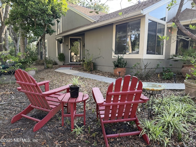 rear view of property with a shingled roof