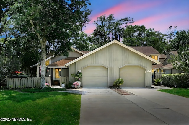 view of front of house featuring an attached garage, concrete driveway, and a shingled roof