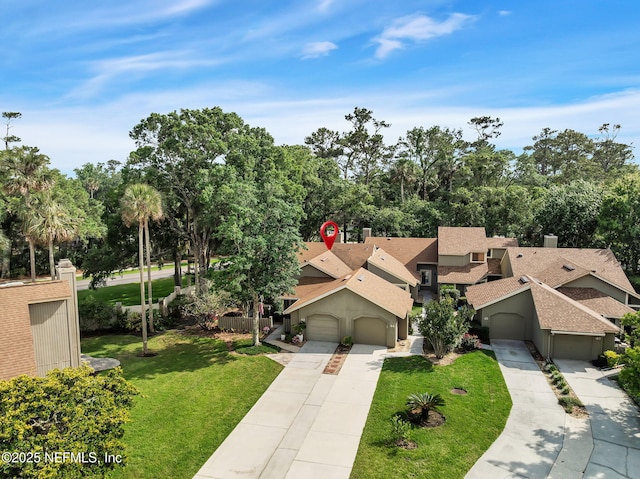 view from above of property featuring a tree filled landscape