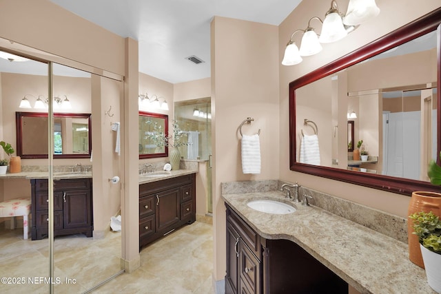 bathroom featuring two vanities and tile patterned floors