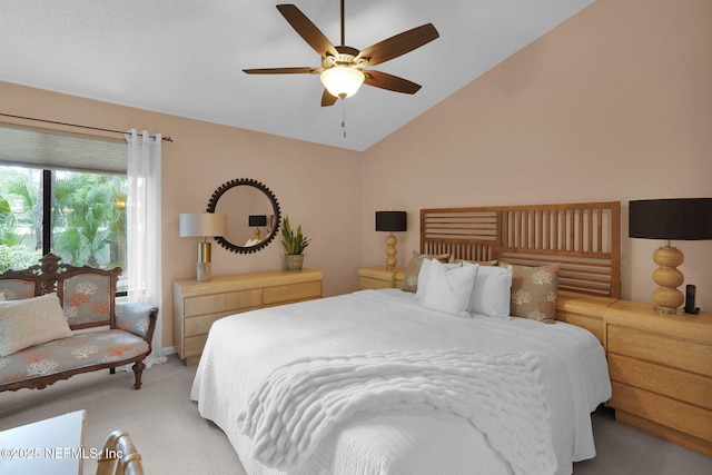 bedroom with light carpet, vaulted ceiling, and ceiling fan