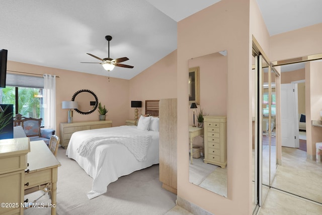 bedroom featuring lofted ceiling, ceiling fan, and light colored carpet