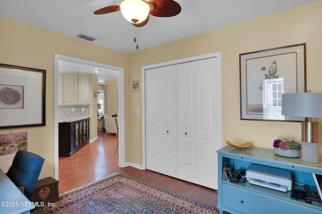 office space featuring wood finished floors, ceiling fan, and baseboards