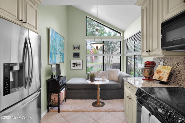 kitchen featuring black appliances, cream cabinetry, light tile patterned flooring, tasteful backsplash, and light stone counters